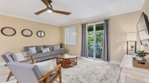 a living room with a couch and a ceiling fan at Beautiful 3 Bedroom Villa in Honokai Hale
