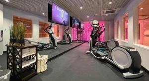 a gym with tread machines and a flat screen tv at Ahern Hotel and Event Center in Las Vegas
