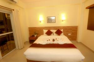 a bedroom with a large bed with towels on it at Hotel Dream Light in Pokhara +4 photos