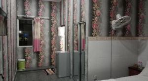 a bedroom with a wall with flowers on it at Unique Hotel in Phnom Penh +48 photos