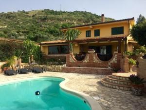 a house with a swimming pool in front of a house at B&B La Collina Felice in Pellaro