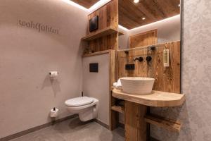 a bathroom with a white toilet and a sink at LAUDEGGHOF Ladis in Ladis +36 photos