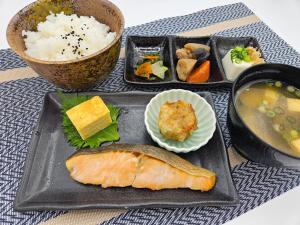 a tray of food with a fish and a bowl of soup at HOTEL SULATA Sapporo (Adult Only) in Sapporo