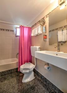 a bathroom with a pink shower curtain and a toilet at Park Hotel in Athens