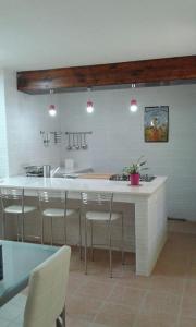 a kitchen with a counter with chairs and a kitchen island at Alba Salentina in Veglie