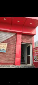 een rood gebouw met een trap ervoor bij NEW Sawan HOTEL in Meerut
