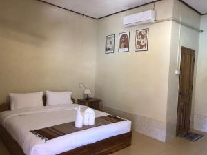 a bedroom with a bed with two white pillows at XAIYASITH guesthouse in Nongkhiaw +4 photos
