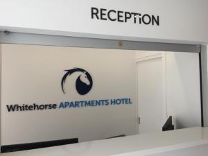 a sign for the whitehorse apartmentments hotel is seen at a building at Whitehorse Apartments Hotel in Box Hill