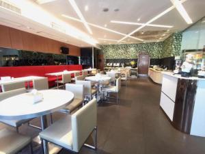 a restaurant with tables and chairs and a counter at Zhangye Pinmu Hotel(Yuncheng Zhongyin Avenue Store) in Yuncheng