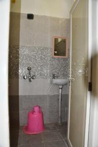 a bathroom with a sink and a pink pot at Elegant Beach View Flat , Bheemili in Bhīmunipatnam