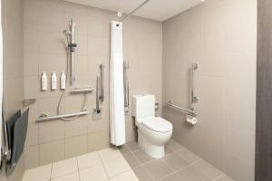 a bathroom with a toilet and a shower stall at Moxy London Excel in London +80 photos