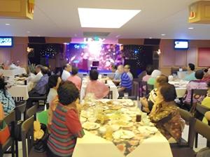 乌汶Ubon Hotel的一群坐在餐桌上吃饭的人