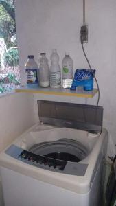 a washing machine with bottles on top of it at Bosque de Ángeles in Buena Vista