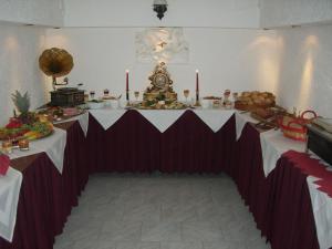 a table in a room with a table with food on it at Hotel Zum Goldenen Löwen in Merseburg