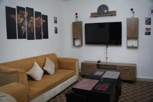 a living room with a couch and a flat screen tv at Petra Bed Hostel in Petra