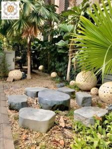 Ban Nam KhongHuern Che Ta One Hotel的有踏脚石、树木和植物的花园
