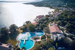 an aerial view of a large swimming pool next to the water at Club Balai Isabel - Audrey-Adam Staycation Balai in Batangas City