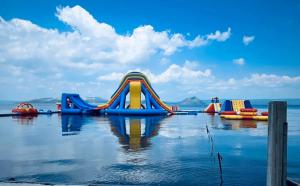 a water park with a slide in the water at Club Balai Isabel - Audrey-Adam Staycation Balai in Batangas City