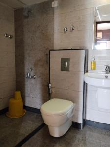 łazienka z toaletą i umywalką w obiekcie Pratham Inn by Downtown Hotels w mieście Manipala +19 zdjęć