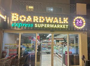 a store with a sign that reads boardwalk express supermarket at Bab Al Bahr 2 BR Apartment in Ras al Khaimah