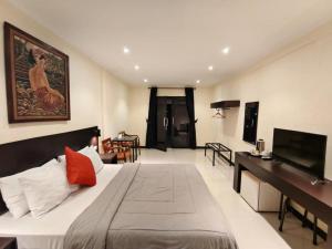 CitepusAugusta Pelabuhan Ratu Hotel的一间带大床的卧室和一间客厅