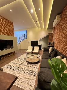 a living room with a couch and a tv at luxury basement studio in Riyadh