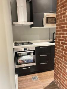 a kitchen with a stove and a microwave at luxury basement studio in Riyadh