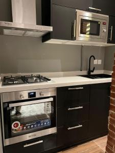 a kitchen with a stove and a microwave at luxury basement studio in Riyadh