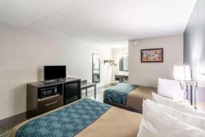 a hotel room with two beds and a flat screen tv at Econo Lodge Crestview South in Crestview +147 photos