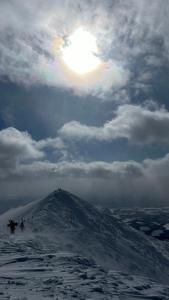 a mountain with the sun on top of it at Ajito Niseko in Kutchan
