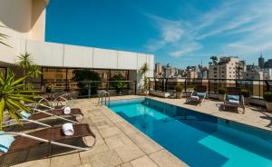a swimming pool on the roof of a building at Transamerica Executive Jardins in Sao Paulo