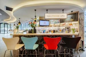 un bar in un ristorante con sedie colorate di Ibis Chengdu Kehua Hotel a Chengdu