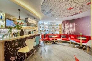 un bar in un ristorante con sedie rosse e blu di Ibis Chengdu Kehua Hotel a Chengdu