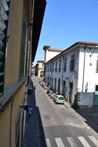 a person walking down a street next to a building at Opera 19 Luxury Apartment in Florence