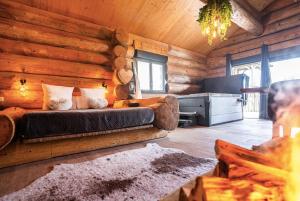 a living room with a couch in a log cabin at Les biquettes Amoureuses in Carspach