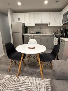 a kitchen with a table and chairs in a room at Relax, Recharge, Repeat 2Bedroom Walkout Haven in Calgary