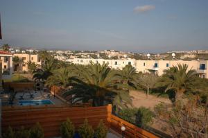 a view of a resort with palm trees and a pool at Villa Vista in Paphos
