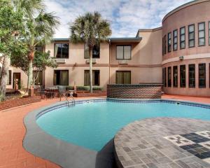 a large swimming pool in front of a building at Baymont By Wyndham Laurel in Laurel