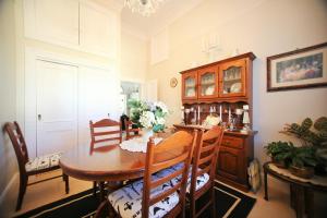 a dining room with a wooden table and chairs at Regan House in Stratford