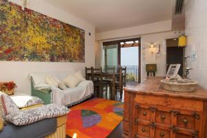 a living room with a couch and a table at Cottage on the Beach in Taormina