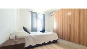 a bedroom with a bed and a large window at Oasis Apartment in Pereybere