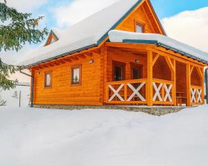 a log cabin in the snow at Drevenička Vodníček in Liptovský Trnovec