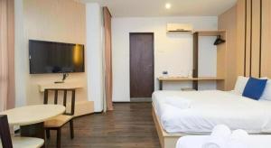a hotel room with a bed and a table and a tv at Grand Kapar Hotel Klang Sentral in Setia Alam +65 photos