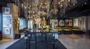 a room with a table and chandeliers at The Hulo Hotel & Gallery in Kuala Lumpur