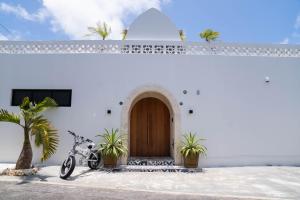 a building with two bikes parked in front of a door at The House By The Sea in Miyako Island +34 photos
