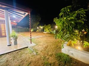 a backyard at night with a swing at Coco Villa Yala in Tissamaharama