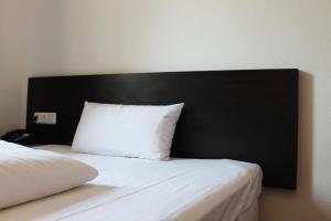 Postel nebo postele na pokoji v ubytování Aariana Hotel + 14 fotografií