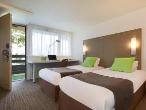 a hotel room with two beds and a desk at Campanile Le Mans - Arnage in Arnage +38 photos