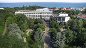 an aerial view of a building with trees and the ocean at Grand-Marine Hotel & SPA in Odesa