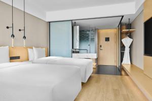 Postel nebo postele na pokoji v ubytování Fairfield by Marriott Dalian Jinpu New Area + 24 fotografií